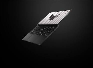 ASUS TUF Gaming A14 open on a dark background showing a 14-inch display panel and sleek chassis.